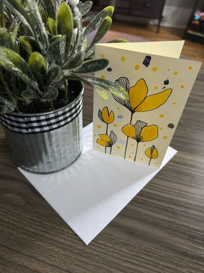 Card with yellow floral design .