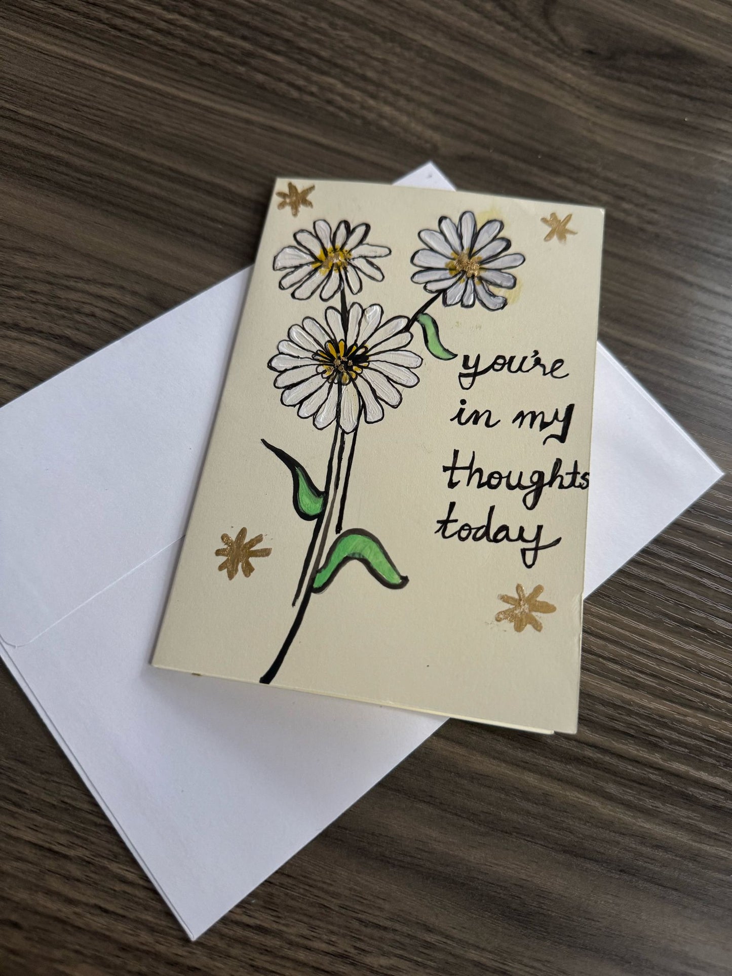 Greeting card with daisy design and text 'you're in my thoughts today' .