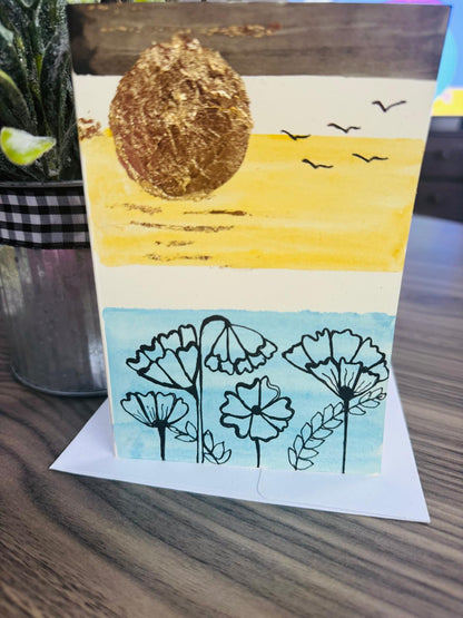 Card with a sun and flowers design 