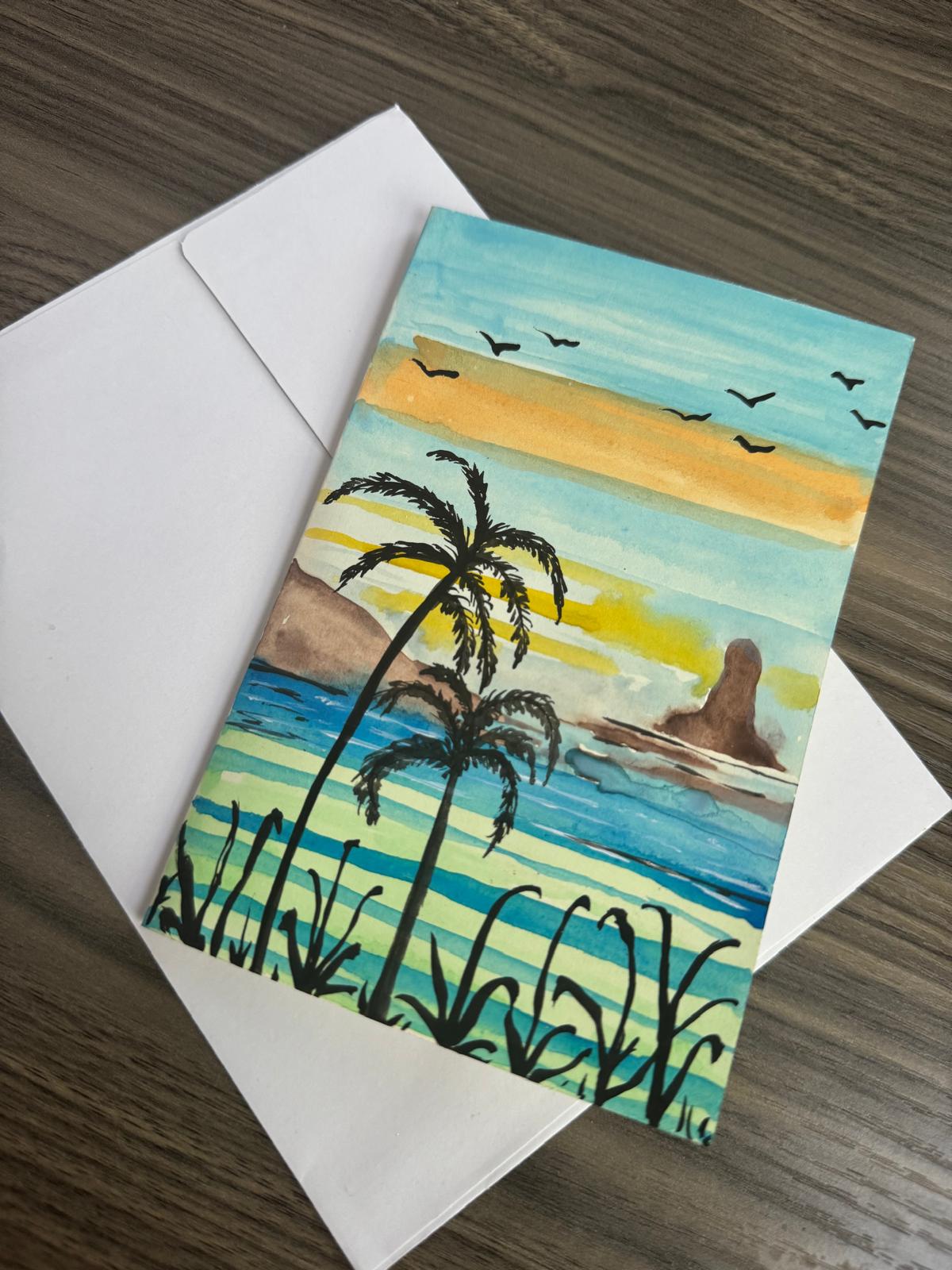 Greeting card with a beach scene featuring palm trees and a sunset