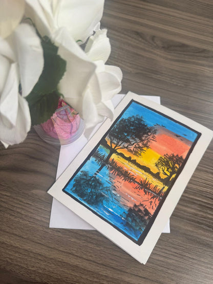 Greeting card with a sunset landscape design .