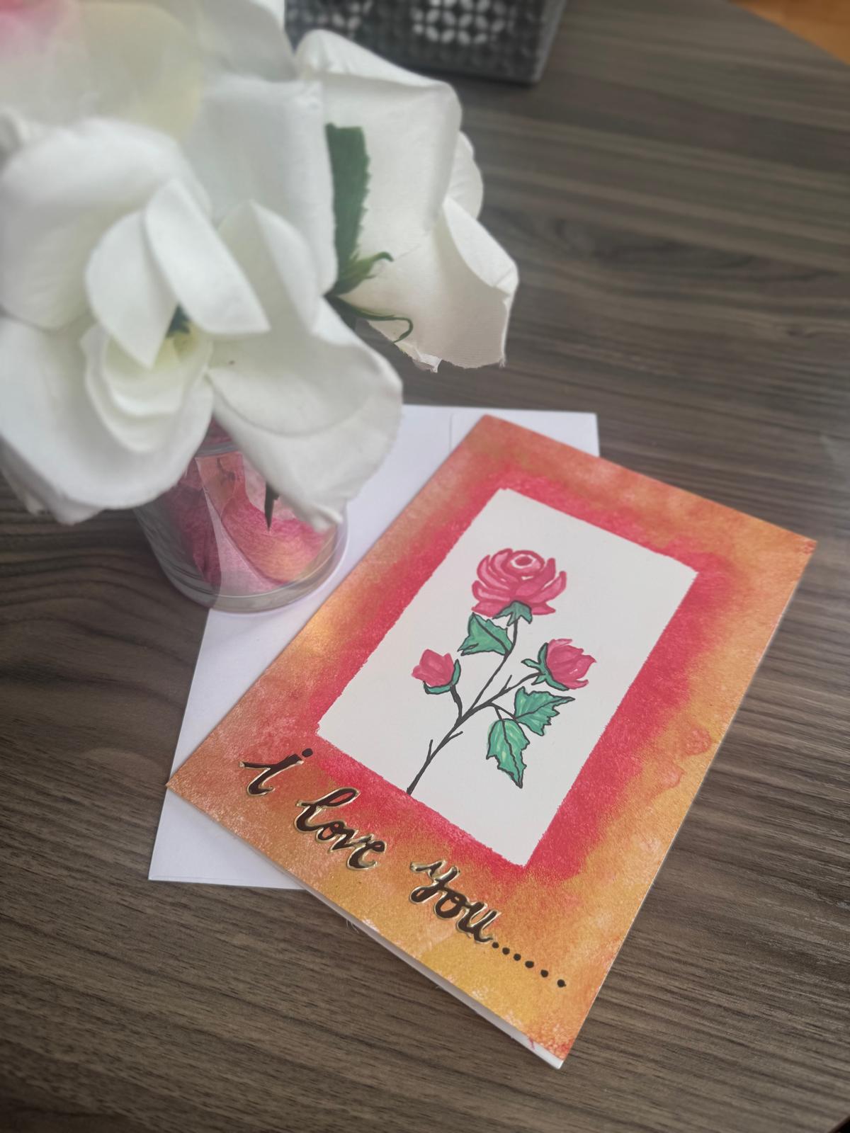 Greeting card with roses and 'I love you' text.