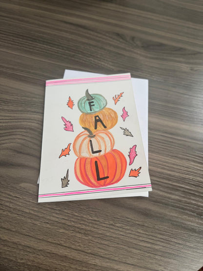 Hand-painted greeting card with stacked pumpkins and autumn leaves spelling FALL – blank inside with envelope.