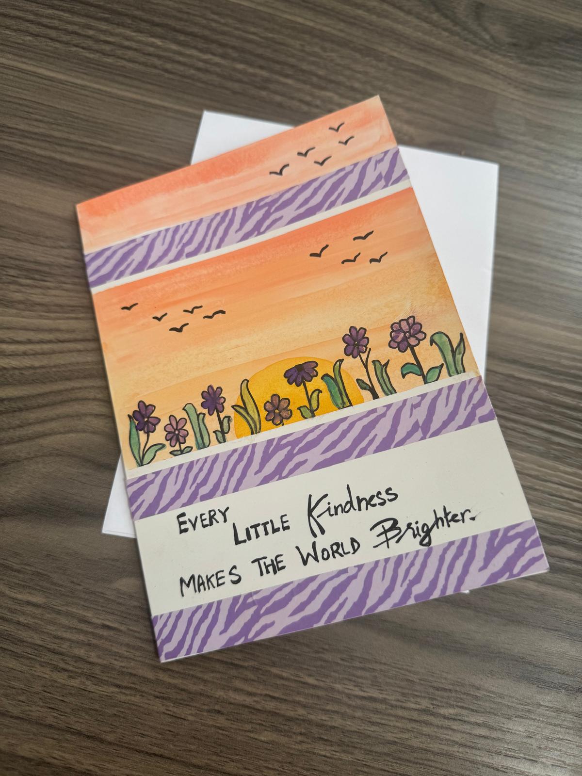Handmade card with a colorful landscape design and motivational quote .