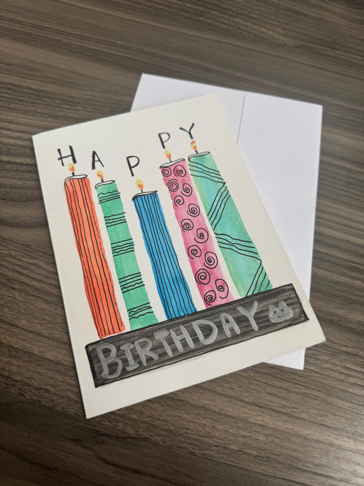 Vibrant handmade birthday card with tall colorful candles, blank inside with matching envelope.